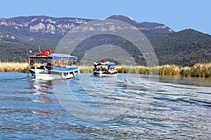 Pleasure boats motor up the Dalyan river, Turkey