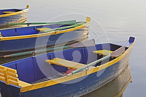 Pleasure boats with oars at the pier on the lake