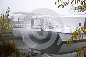 Pleasure boats on the pier, autumn morning