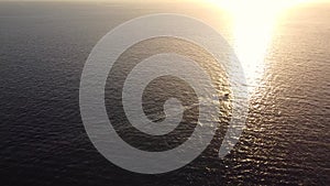 Pleasure boats sailing along the rocky beach, aerial view of the coastline at sunset. Gran Canaria