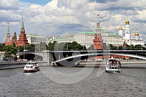 Pleasure boats sails along the river near the Moscow Kremlin.