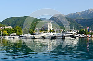 Pleasure boats and yachts at pier on promenade of Budva, Montenegro