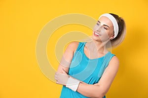 Pleasure fitness girl looking up and wearing sport clothing - sportswear, isolated on yellow background. Beautiful vitality woman