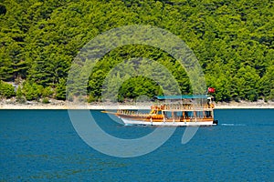 Pleasure motor yacht in the Green Canyon in Turkey.