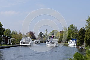 Pleasure motor yacht sailing over a narrow channel between the h