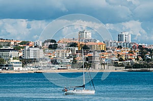 Pleasure vessel in Cascais Bay with Estoril in background, Portugal