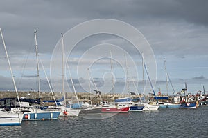 Pleasure yachts in a marina on a clouded sky