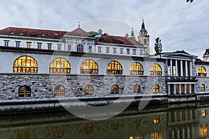 Plecnik arcade market building reflecting in Ljubljanica river in Ljubljana, Sloven