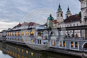 Plecnik arcade market building reflecting in Ljubljanica river in Ljubljana, Sloven