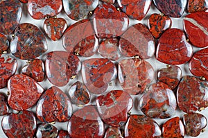 Plenty of brecciated jasper heart stones as background