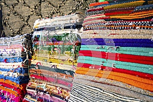 Plenty of famous traditional Berber carpets on sale, in Morocco