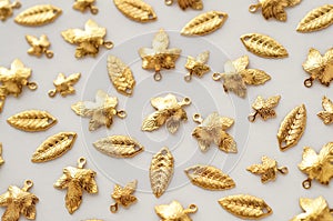 Plenty of gold shining metal leaves. Jewelry findings