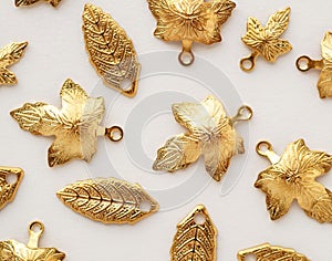 Plenty of gold shining metal leaves. Jewelry findings