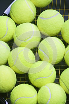 Plenty of tennis Balls on Raquet Strings