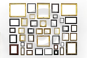 Plenty of white clipped paintings frame hanging on a white wall. Copy or empty space for mockups or templates. Museum Art