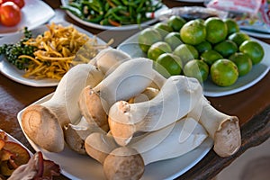 Pleurotus eryngii Mushroom and assorted raw vegetables ready to cook on brown table, origin mushroom photo