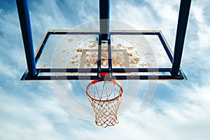 Plexiglass street basketball board with hoop on outdoor court photo