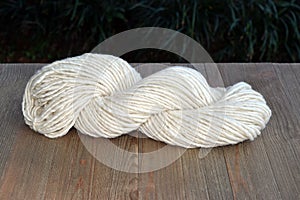 Plied Yarn Skein in the Sun on a Wood Table