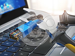 Pliers cutting lan network computer cable over laptop keyboard.
