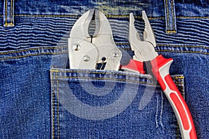 Pliers in pocket of blue jeans