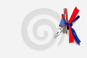 Pliers screwdriver metal pliers screwdriver cutter flag red blue white ribbon bow postcard background labor Dutch