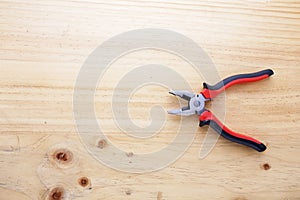 A pliers on a wood table