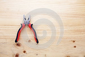 A pliers on a wood table
