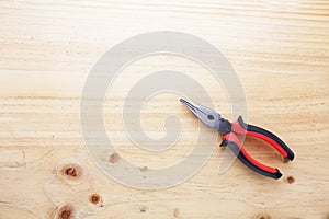 A pliers on a wood table