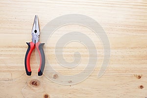 A pliers on a wood table