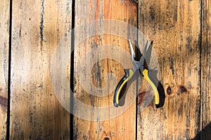 Pliers on wooden surface