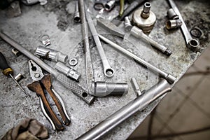 Pliers and wrenches on the table in the garage.