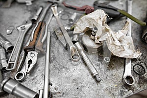 Pliers and wrenches on the table in the garage.