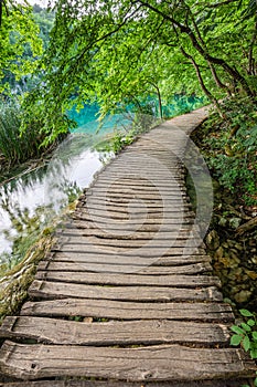 Plitvice, Croatia - Wooden walkway in Plitvice Lakes National Park on a bright summer day with crystal clear turquoise water