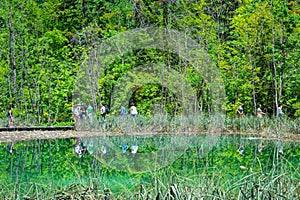 Wooden pathway reflected in lake in Plitvice Lakes National Park, Croatia