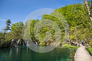 Plitvice Lakes National Park, Croatia. Tourists walk on the wood bridge