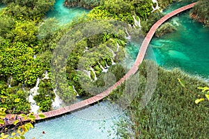 Plitvice lakes national Park, Croatia. Walkway bridge over the pond that passes by the amazing little waterfalls