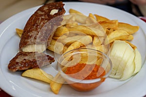 pljeskavica filled with cheese popular pork dish in balkan plate with ajvar and fries photo