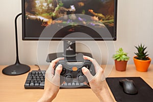 Pllaying on the joystick in a game console.