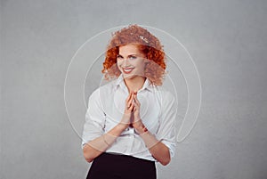 Plot. Closeup portrait of sneaky, sly, scheming young woman plotting something isolated on gray wall background. Negative human