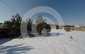 Plot of land in winter. Construction of a private house. Fence on the land in winter