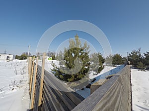 Plot of land in winter. Construction of a private house. Fence on the land in winter