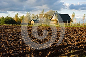 Ploughed field and house