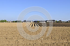 Ploughed field and houses
