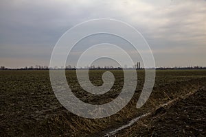 Ploughed field in the italian countryside in winter