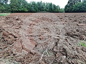 Ploughed soil in  farmlands landscape  in italy photo