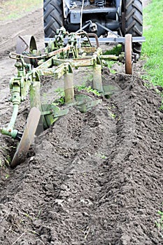 Ploughing with old-time plough with three plow blades