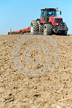 Ploughing tractor at field cultivation work