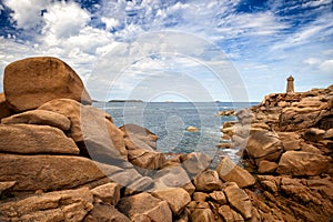 Ploumanac`h Mean Ruz lighthouse between the rocks in pink granite coast, Perros Guirec, Brittany, France.