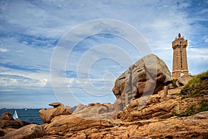 Ploumanac`h Mean Ruz lighthouse between the rocks in pink granite coast, Perros Guirec, Brittany, France