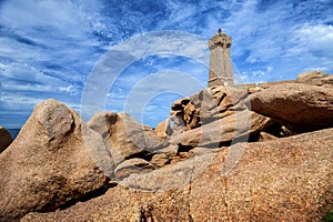 Ploumanach Mean Ruz lighthouse between the rocks in pink granite coast, Perros Guirec, Brittany, France